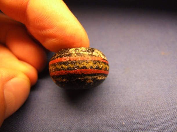 Skleněný korálek z doby římské z Holubic.